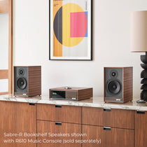 Ruark Sabre-R Bookshelf Speakers in Fused Walnut veneer cabinet and slat detailing, shown with R610 Music Console